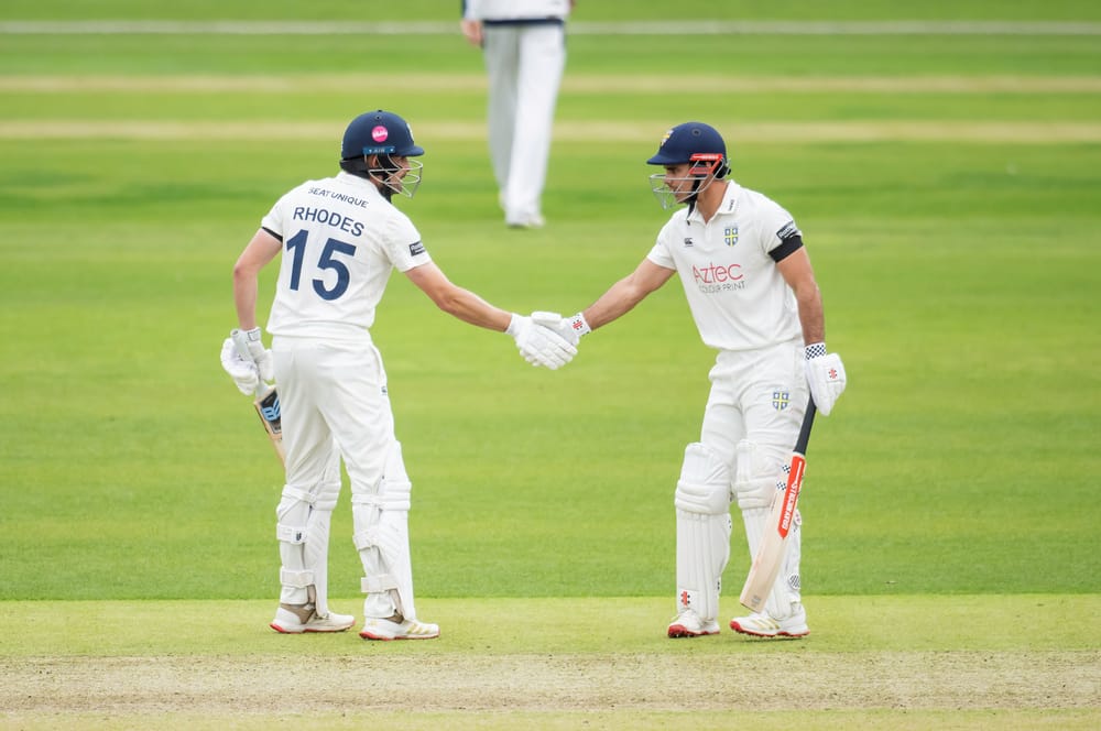 David Bedingham and Will Rhodes punch gloves during Durham's County Championship clash with Yorkshire.