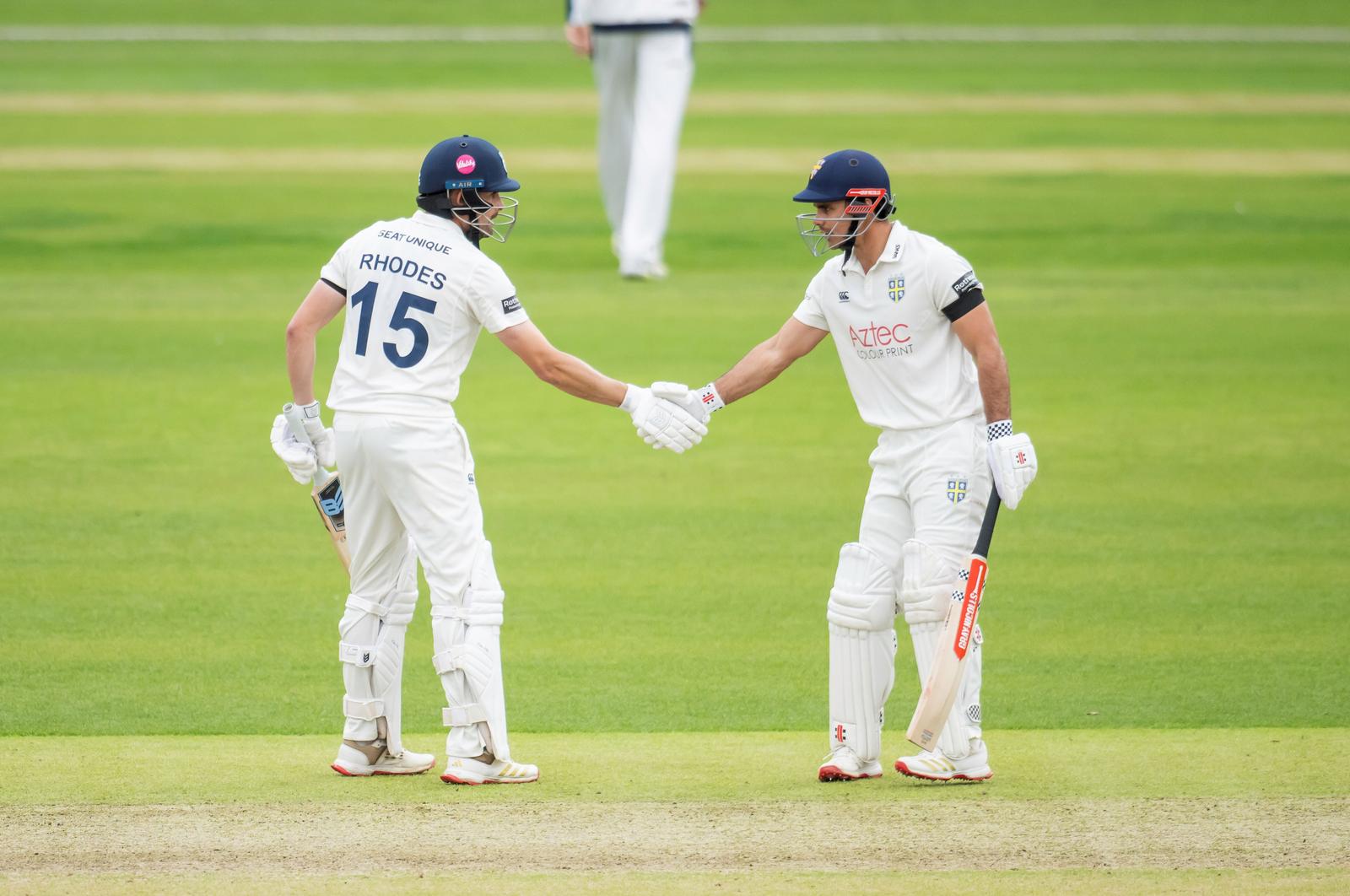 David Bedingham and Will Rhodes punch gloves during Durham's County Championship clash with Yorkshire.