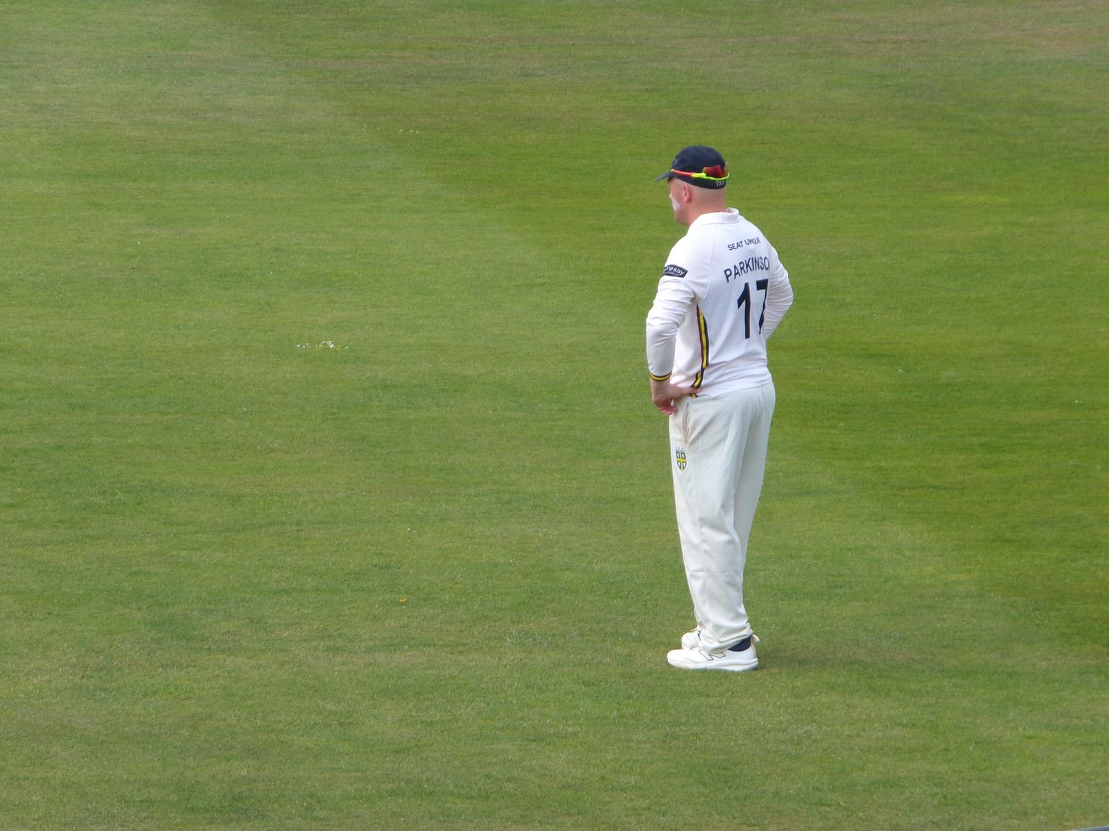 Callum Parkinson watching on in the field during Durham's Rothesay County Championship fixture against Northamptonshire