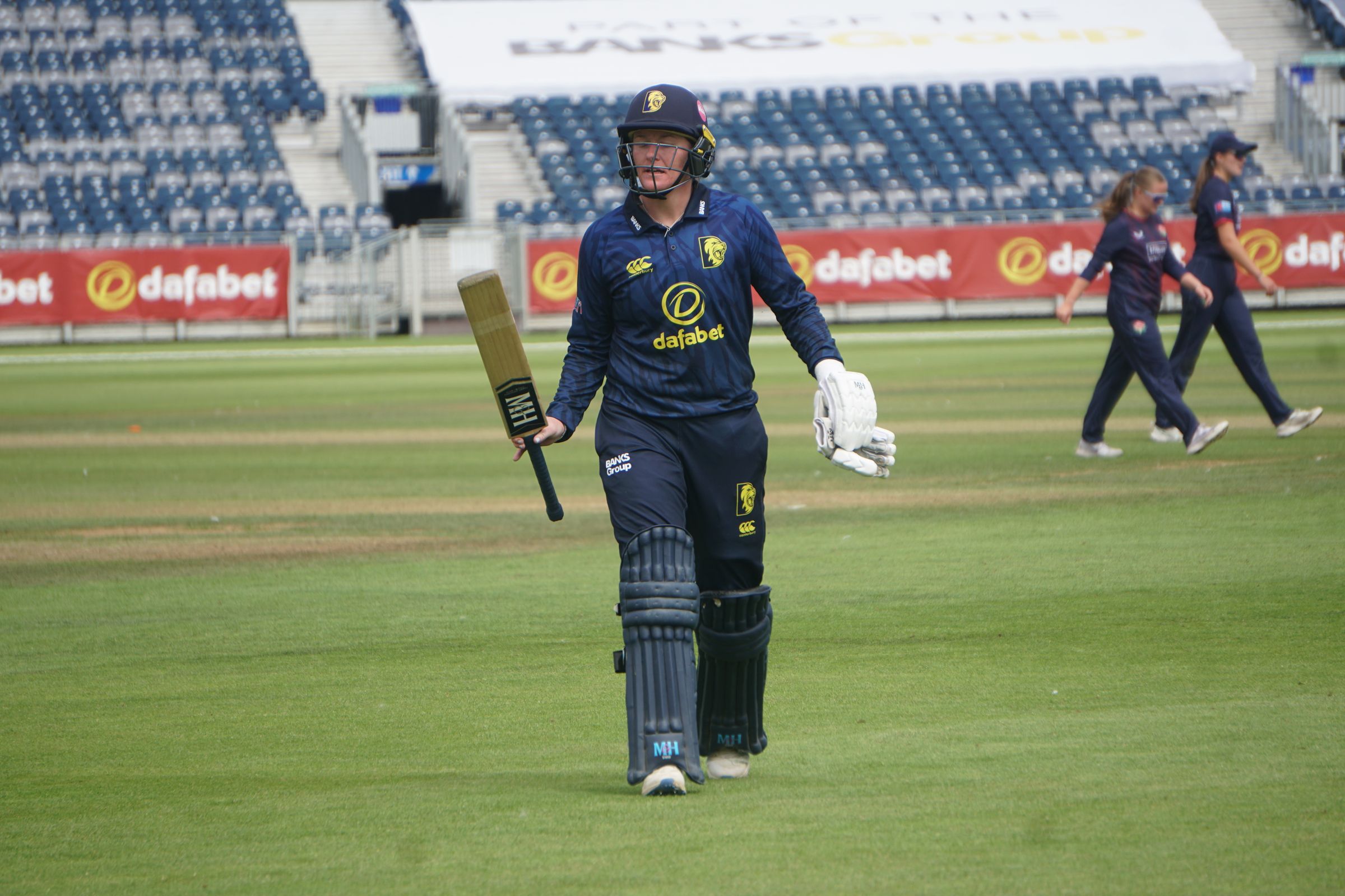 Hollie Armitage raising her bat while leaving the field after a fine knock of 111 in Durham's 89-run triumph over Lancashire.