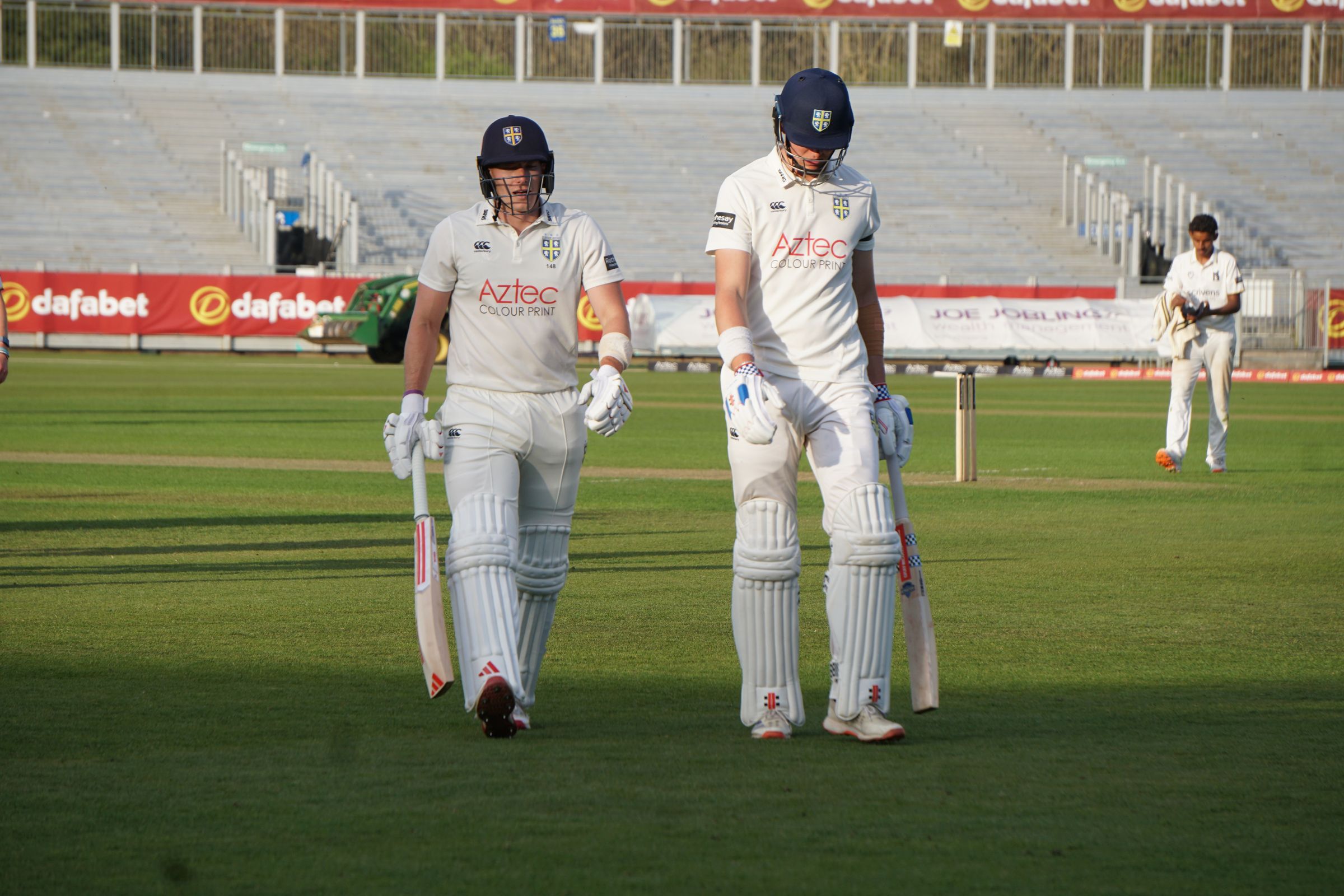 Durham's Ben McKinney and Matthew Potts walking off the field of play after a day of play in the Rothesay County Championship.