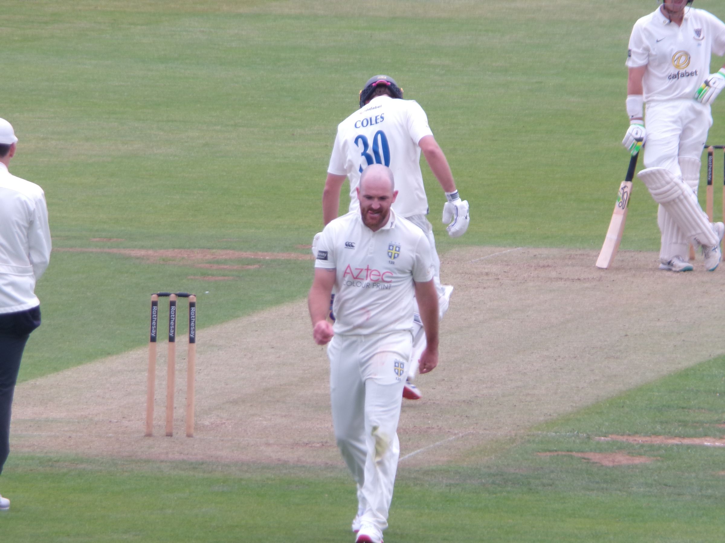 Ben Raine walks back from the crease after bowling a delivery against Sussex last year