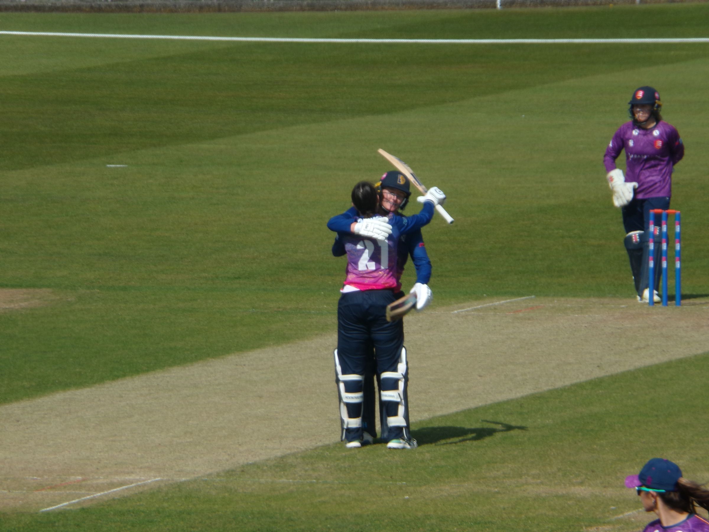 Tahlia Wilson and Hollie Armitage embrace after Wilson reaches a century for the first time in a Durham shirt